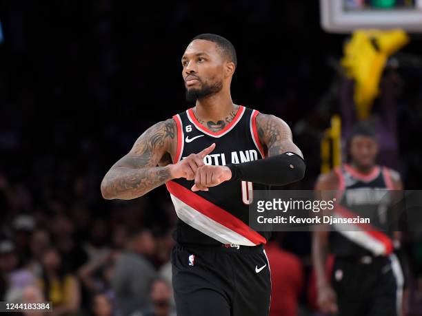 Damian Lillard of the Portland Trail Blazers celebrates as he points to his wrist after scoring a three-pot basket in the closing seconds of the game...