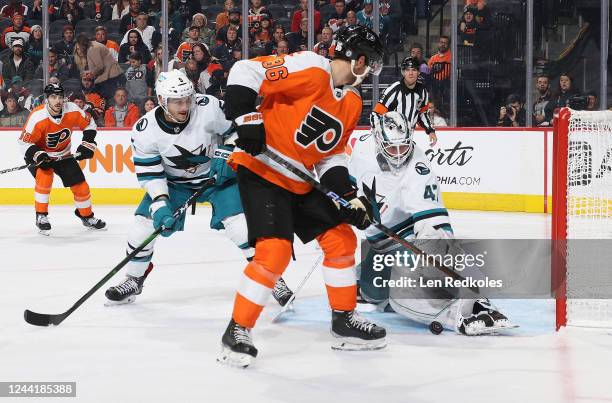 Goaltender James Reimer of the San Jose Sharks makes a pad save as Matt Benning defends against Joel Farabee of the Philadelphia Flyers at the Wells...