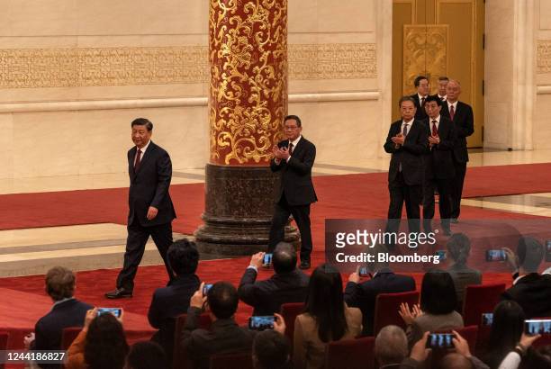 Xi Jinping, China's president, left, and members of the Communist Party of China's new Politburo Standing Committee, arrive for its unveiling at the...