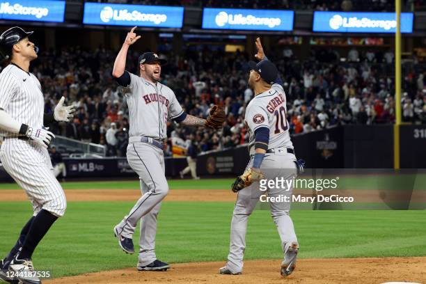 Ryan Pressly and Yuli Gurriel of the Houston Astros celebrate on the field after Astros defeated the New York Yankees in Game 4 of the ALCS at Yankee...