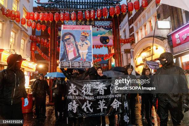 Protesters holding Hong Kong protest flags and placards arrive at China Town during an anti-Chinese Communist Party assembly in London. Hundreds of...