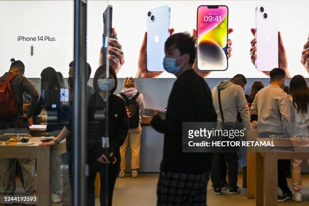 People visit an Apple store in Shanghai on October 24, 2022.