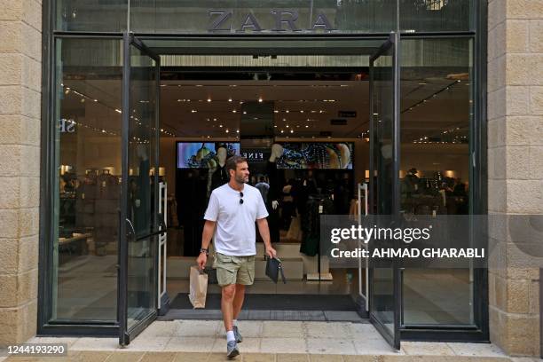 Man leaves a Zara shop in Jerusalem on October 24, 2022. - Spanish fashion giant Zara is facing boycott calls in Israel after the company's local...