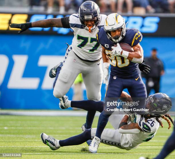 Inglewood, CA, Sunday, October 23, 2022 - Los Angeles Chargers running back Austin Ekeler is pursued by Seattle Seahawks defensive tackle Quinton...