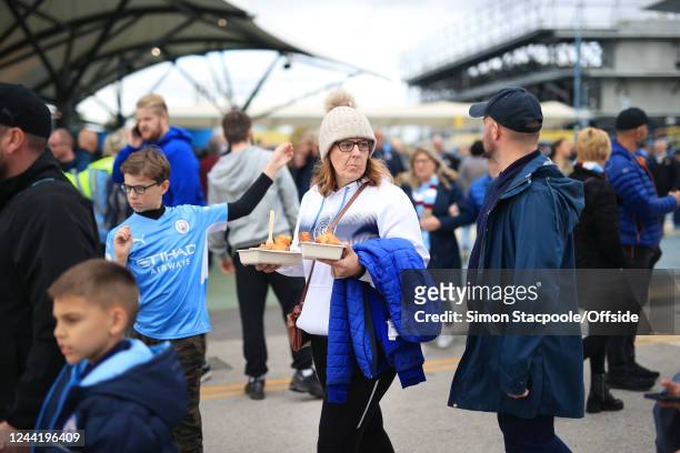 Woman carries her fish and chips before the Premier League match between Manchester City and Brighton & Hove Albion at Etihad Stadium on October 22,...
