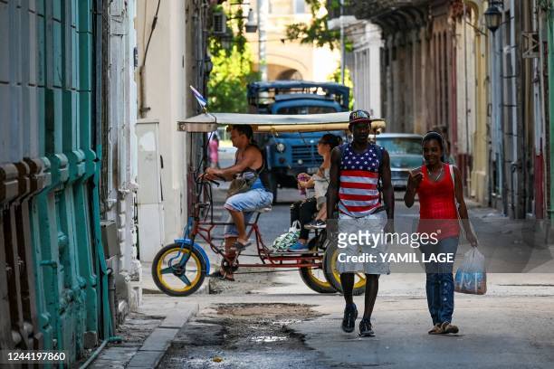People walk on a street in Havana, on October 24, 2022.