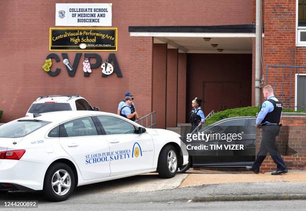 St. Louis metropolitan police officers stand outside an entrance at the northeast corner of the Central Visual and Performing Arts High School after...