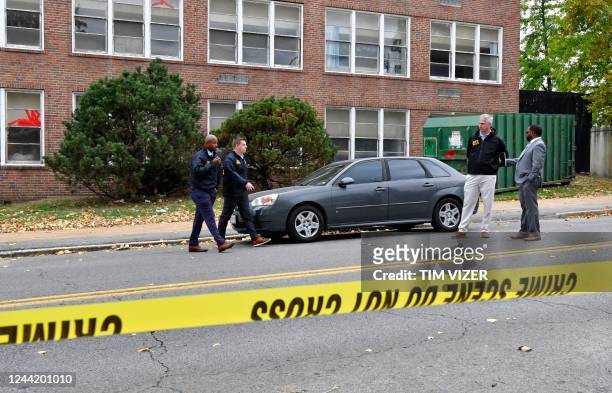 St. Louis Metropolitan police and Alcohol, Tobacco & Firearms officers stand outside the Central Visual and Performing Arts High School after a...