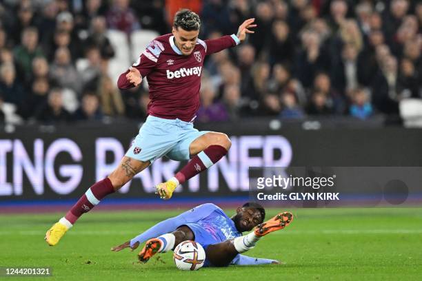 West Ham United's Italian striker Gianluca Scamacca jumps over Bournemouth's Colombian midfielder Jefferson Lerma during the English Premier League...