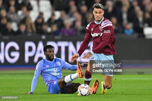 Bournemouth's Colombian midfielder Jefferson Lerma fights for the ball with West Ham United's Italian striker Gianluca Scamacca during the English...