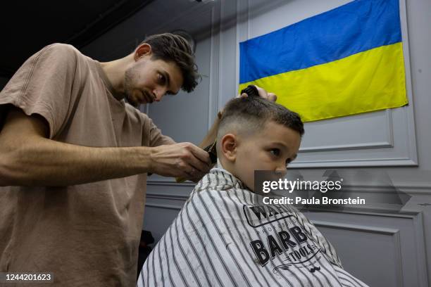 At the Gentleman's club barber shop Dmytro gets his hair cut by barber Dmytro Panasiuk on October 24, 2022 in Irpin, Ukraine. In the early days of...