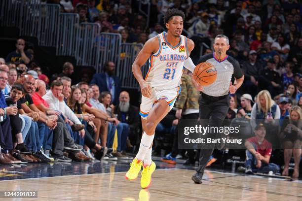 Aaron Wiggins of the Oklahoma City Thunder dribbles the ball against the Denver Nuggets on October 22, 2022 at the Ball Arena in Denver, Colorado....