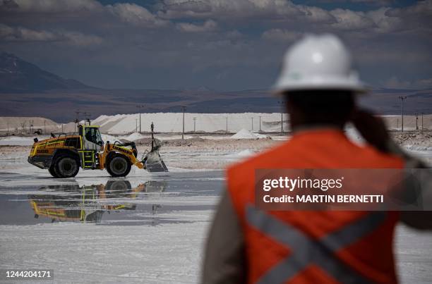 Worker observes machinery in a brine pool at Chilean company SQM's lithium mine in the Atacama Desert, Calama, Chile, on September 12, 2022. - The...