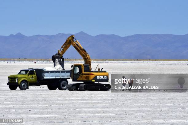 Employees work at the Salinas Grandes salt flat near the Kolla indigenous community of Santuario de Tres Pozos, which in 2019 expelled two mining...
