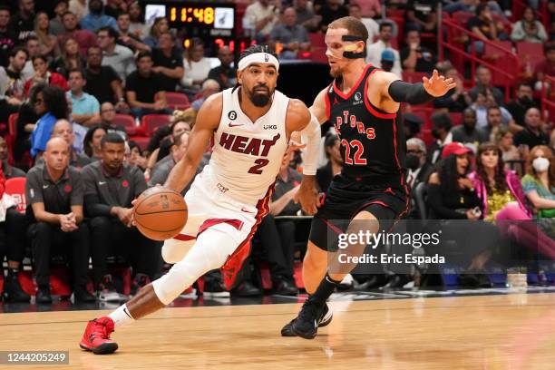 Gabe Vincent of the Miami Heat drives past Malachi Flynn of the Toronto Raptors during the fourth quarter of the game at FTX Arena on October 24,...