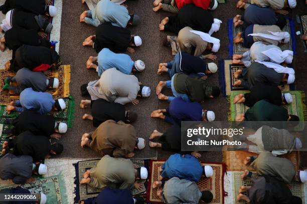 Palestinian students dressed Sharia uniform, attend prayer lessons at Al-Taabieen Sharia School in Gaza City on October 24, 2022. There are ten...