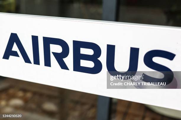 Photograph shows an information sign depicting the logo of Airbus at the entrance of a building of the Airbus Defence and Space headquarters in...