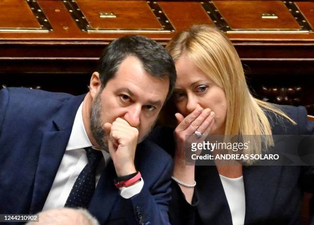 Italys new Prime Minister Giorgia Meloni talks with Deputy Prime Minister and Minister of Infrastructure, Matteo Salvini after her first address to...