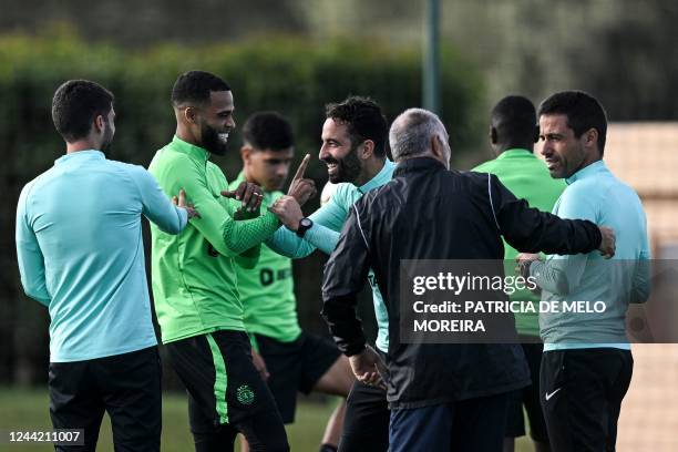 Sporting Lisbon's Portuguese coach Ruben Amorim laughs with Sporting Lisbon's Dutch defender Jerry St. Juste during a training session at the...