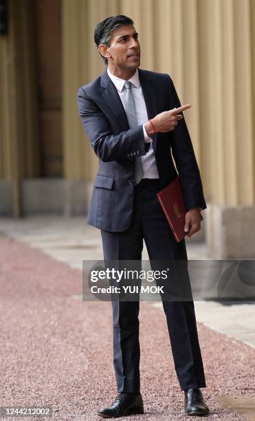 New Conservative Party leader and Britain's Prime Minister Rishi Sunak gestures as he leaves from Buckingham Palace in London on October 25 following...