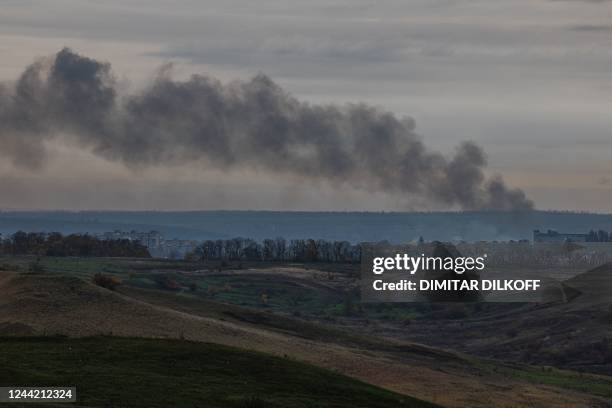 This photograph taken on October 25, 2022 shows a black smoke spreads up over the town of Bakhmut, Donetsk region, amid the Russian invasion of...