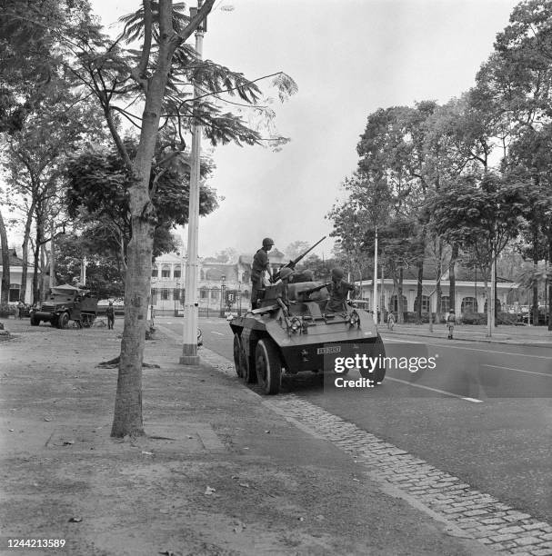 Armored vehicles ready to fire take position in front of the Independence Palace where the President of the Republic of Vietnam Ngo Dinh Diem and his...