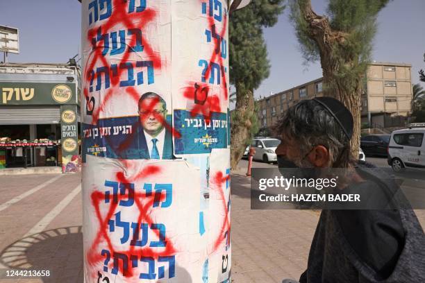 Defaced electoral posters of Israeli far-right Otzma Yehdit party leader Itamar Ben-Gvir, are pasted in the southern city of Beersheva, on October...