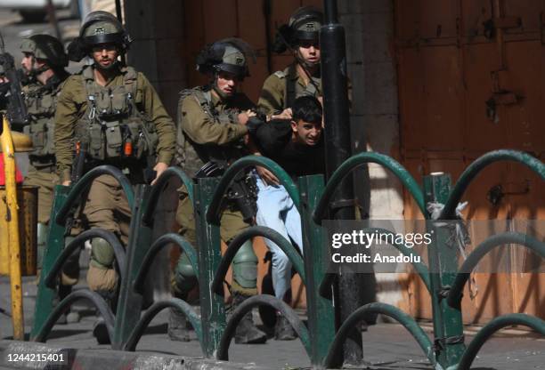 Israeli forces take into custody a Palestinian as Palestinians gather for a protest over the killing of 6 Palestinians by the Israeli soldiers in...