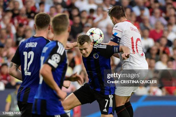 Copenhagen's Swedish midfielder Viktor Claesson vies with Sevilla's Croatian midfielder Ivan Rakitic during the UEFA Champions League 1st round day...