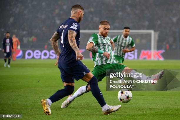 Maccabi Haifa's French defender Pierre Cornud fights for the ball with Paris Saint-Germain's Spanish defender Sergio Ramos during the UEFA Champions...