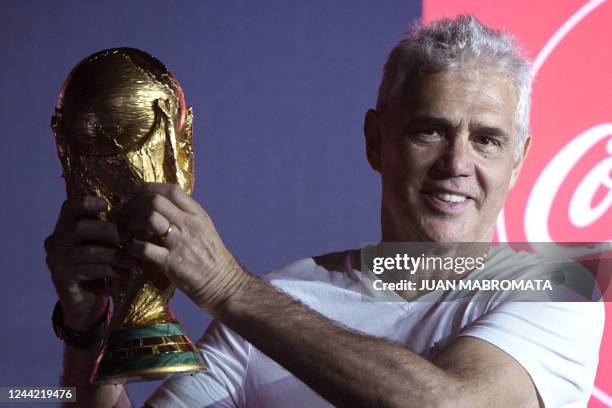 Argentina's 1978 World Cup Champion Alberto Tarantini holds the FIFA World Cup trophy in Ezeiza, Buenos Aires, on October 25, 2022 during the world...
