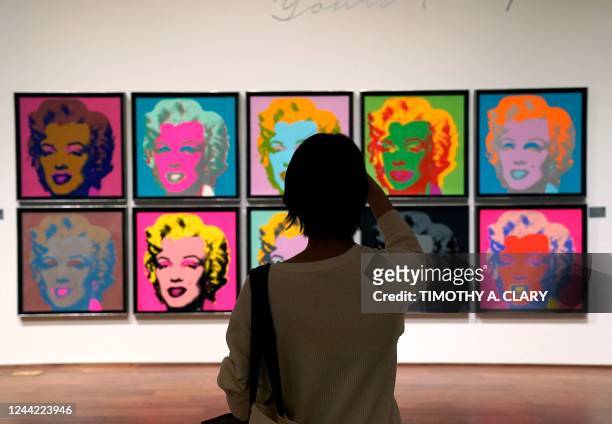 Woman looks at Andy Warhols Marilyn Monroe at Sothebys New York on October 25, 2022 during a preview for Andy Warhol: Yours Truly An Important...