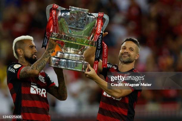 Arturo Vidal and Diego Ribas of Flamengo hold up the Copa do Brasil trophy before a match between Flamengo and Santos as part of Brasileirao 2022 at...