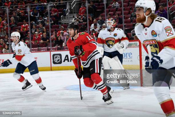 Taylor Raddysh of the Chicago Blackhawks looks up the ice in between Matt Kiersted and Marc Staal of the Florida Panthers in the first period at...