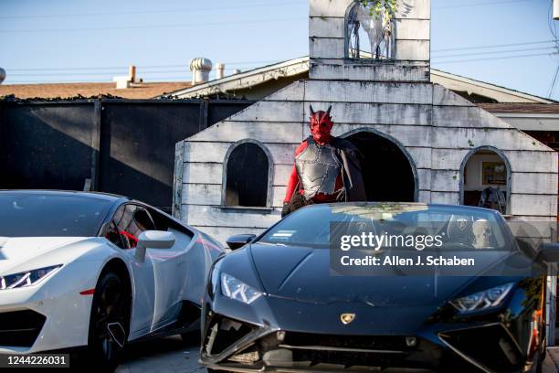 Santa Ana, CA Joshua Screwloose Shibley is in costume as Satan with two Lamborghinis at Jesus Chewie Garcias beginning stages of his halloween...