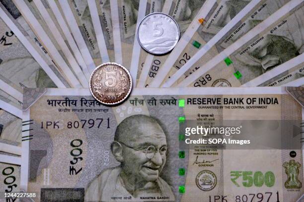 In this photo illustration, Indian Currency note of INR 500 & INR 5 Coin is displayed .