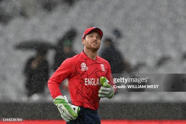 England's Captain Jos Buttler runs off the field as rain delays play during the ICC men's Twenty20 World Cup 2022 cricket match between England and...