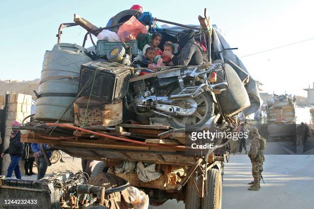 Syrians refugees prepare to leave Lebanon towards Syrian territory through the Wadi Hamid crossing in Arsal on October 26, 2022. - A first batch of...