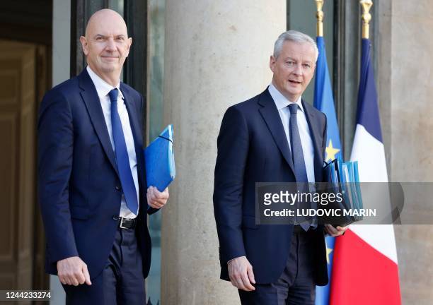 France's Junior Minister for the Industry Roland Lescure and France's Minister for the Economy and Finances Bruno Le Maire leave after the weekly...
