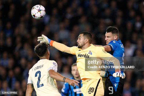 Porto's Portuguese goalkeeper Diogo Costa fights for the ball with Club Brugge's Spanish forward Ferran Jutgla during the UEFA Champions League Group...