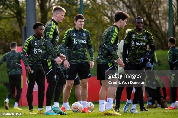 Harry Maguire of Manchester United looks on with team-mates during a Manchester United training session at Carrington Training Ground on October 26,...