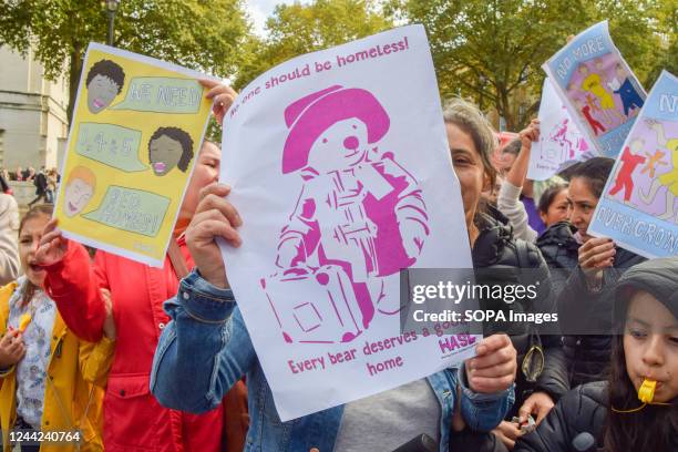 Protester holds a "No one should be homeless" placard with a picture of Paddington Bear during the demonstration outside Downing Street. Hundreds of...