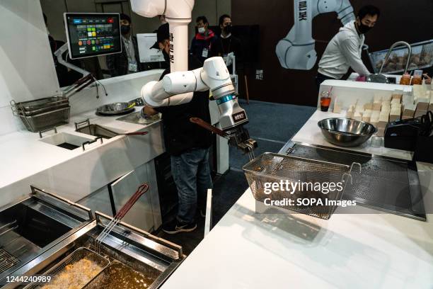 Robot cooks fried chicken during the event. Robotworld 2022 is held at Kintex in Goyang City, Gyeonggi Province. About 600 booths of 200 companies...