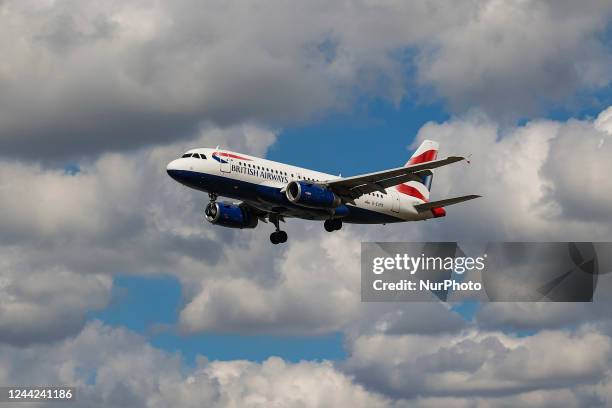 British Airways Airbus A319 aircraft as seen on final approach flying for landing at London Heathrow Airport LHR during a blue sky day with white...