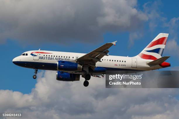 British Airways Airbus A319 aircraft as seen on final approach flying for landing at London Heathrow Airport LHR during a blue sky day with white...