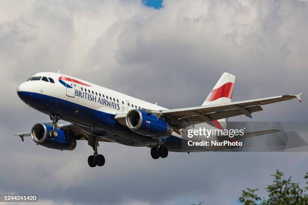 British Airways Airbus A319 aircraft as seen on final approach flying for landing at London Heathrow Airport LHR during a blue sky day with white...