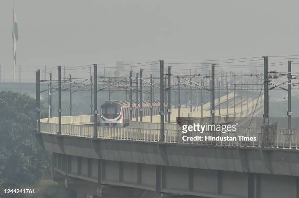 Delhi Metro train leaves from Akshardham station amid dense morning smog on October 26, 2022 in New Delhi, India. Two days after the Diwali...