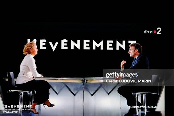 In this screen shot made in Paris on October 26, 2022 French president Emmanuel Macron speaks during an interview by French journalist and TV host...