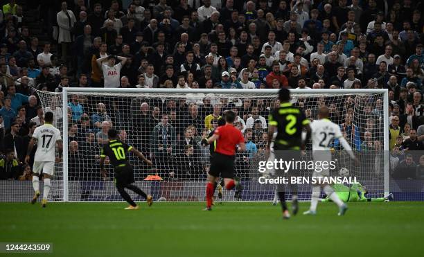 Sporting Lisbon's English striker Marcus Edwards watches his shot into the net as he scores the opening goal past Tottenham Hotspur's French...