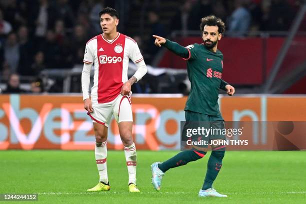 Liverpool's Egyptian striker Mohamed Salah celebrates scoring his team's first goal as Ajax's Mexican defender Edson Alvarez looks on during the UEFA...